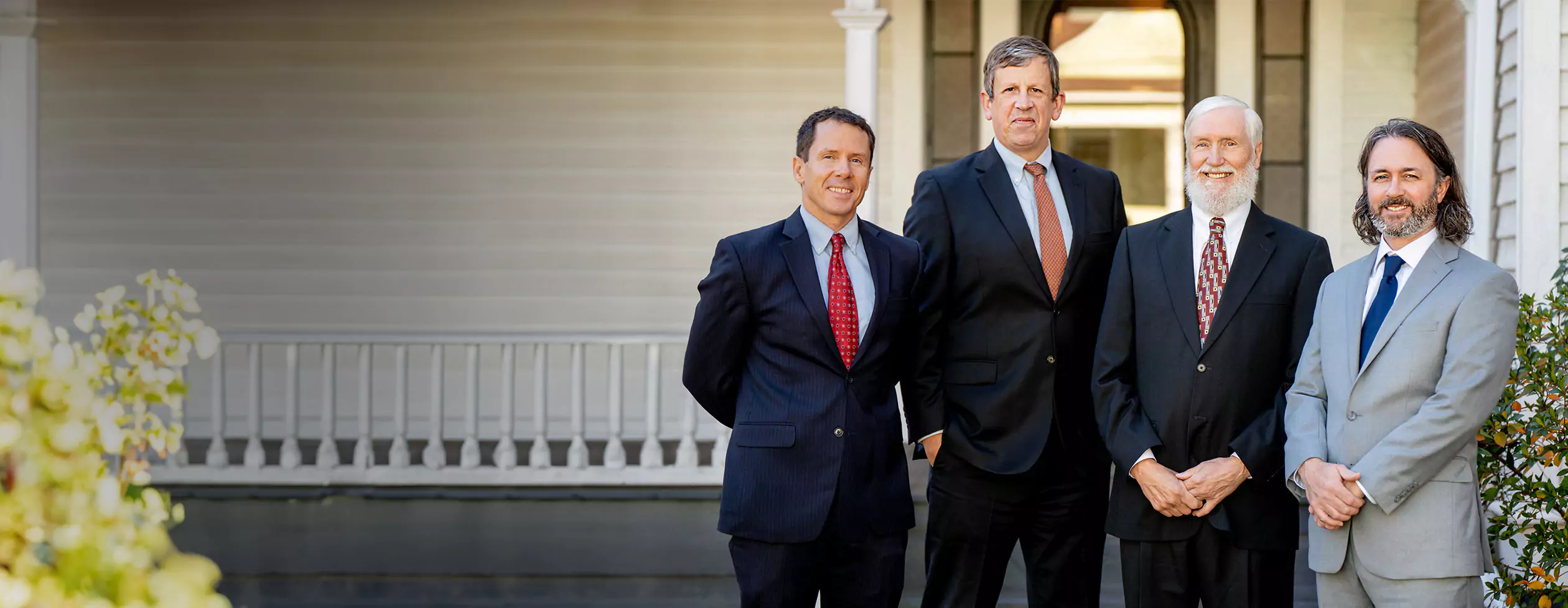 Georgia Social Security Disability lawyers from Silver & Archibald, Patrick Cates, Michael Keene, Kent Silver and Ben Walters, stand in front of one of the firm's offices in Athens.