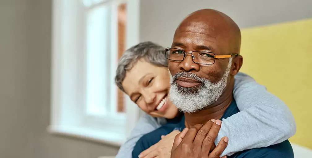 A man looks toward the camera while a woman hugs him from behind. The Silver & Archibald Georgia disability attorneys help with multiple types of injury and disability claims.
