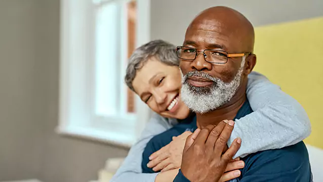 A man looks toward the camera while a woman hugs him from behind. The Silver & Archibald Georgia disability attorneys help with multiple types of injury and disability claims.