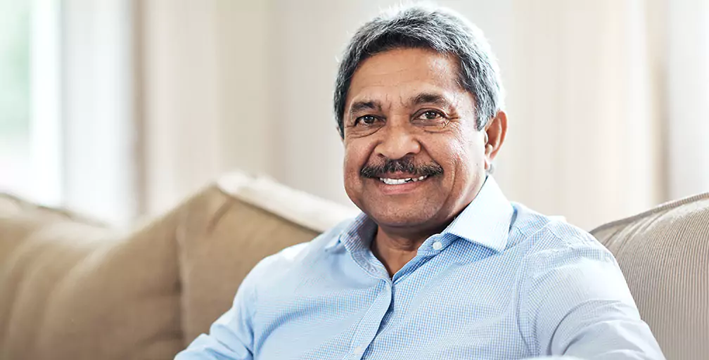 A man sitting on a couch smile toward the camera. The Georgia Social Security Disability lawyers at Silver & Archibald have secured more in benefits for people than any other Georgia-based firm.
