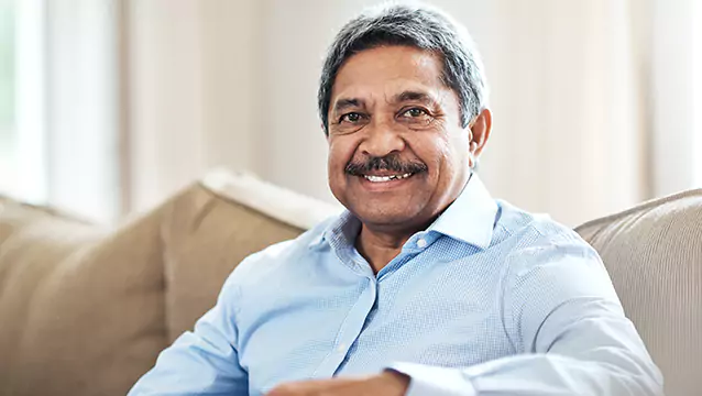 A man sitting on a couch smile toward the camera. The Georgia Social Security Disability lawyers at Silver & Archibald have secured more in benefits for people than any other Georgia-based firm.